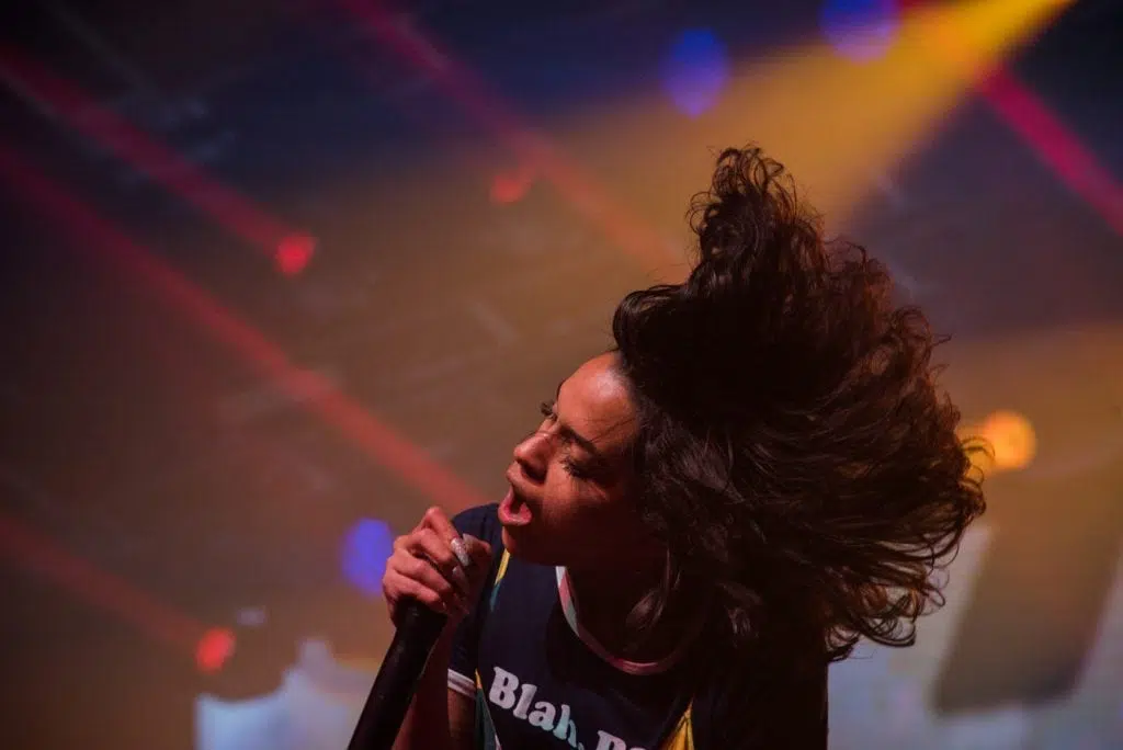 a woman singer singing into a microphone on a festival at Balaton Sound